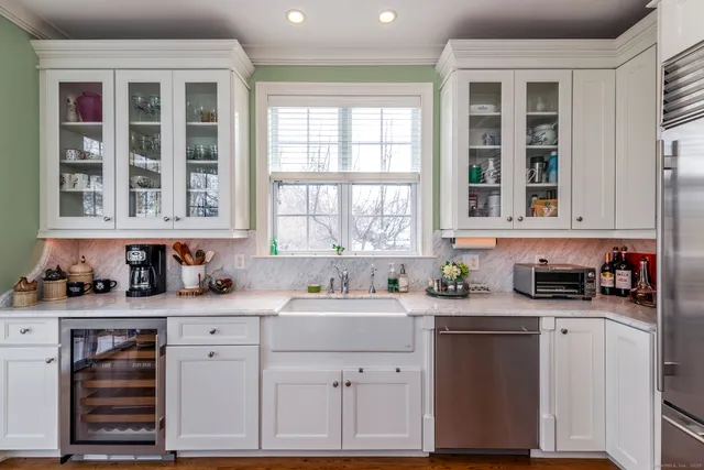 a kitchen with stainless steel appliances a sink stove and cabinets