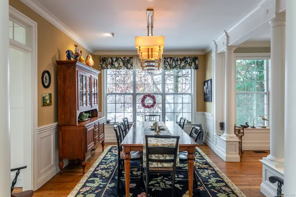 a view of a dining room with furniture window and wooden floor