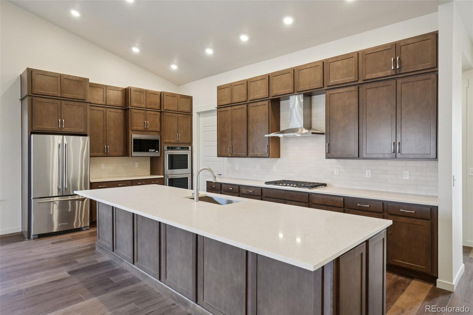 1726 Morningstar Way Fort Collins, CO 80524 - Photo 14 of 50 a kitchen with stainless steel appliances granite countertop a sink a stove and a refrigerator