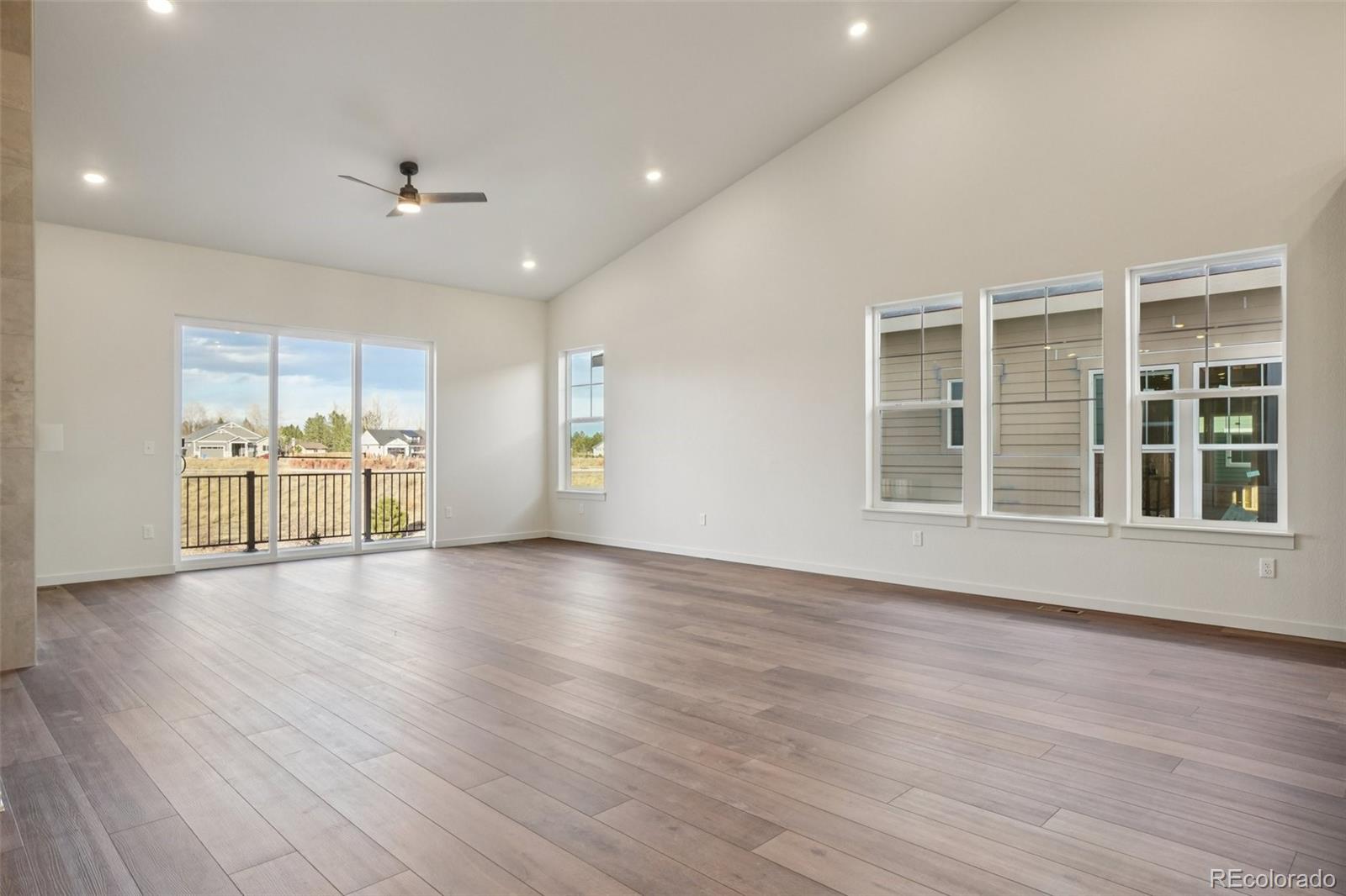 1726 Morningstar Way Fort Collins, CO 80524 - Photo 5 of 50 a view of an empty room with a window and wooden floor