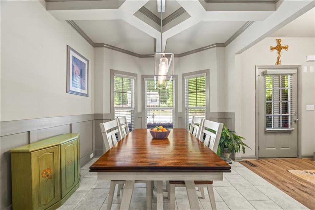 816 Mimosa Way Jefferson, GA 30549 - Photo 17 of 83 a view of a dining room with furniture a chandelier and wooden floor