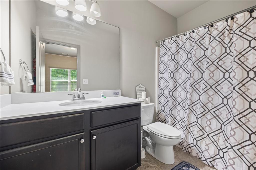 816 Mimosa Way Jefferson, GA 30549 - Photo 22 of 30 a bathroom with a toilet a sink and mirror
