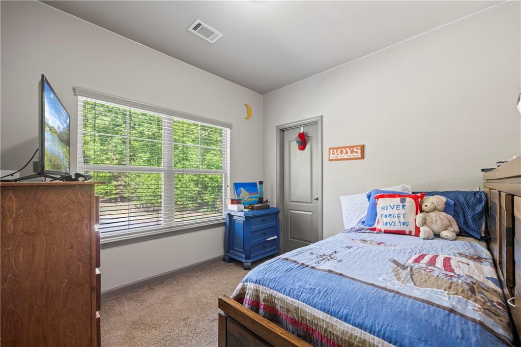 816 Mimosa Way Jefferson, GA 30549 - Photo 23 of 30 a bedroom with a bed and a window
