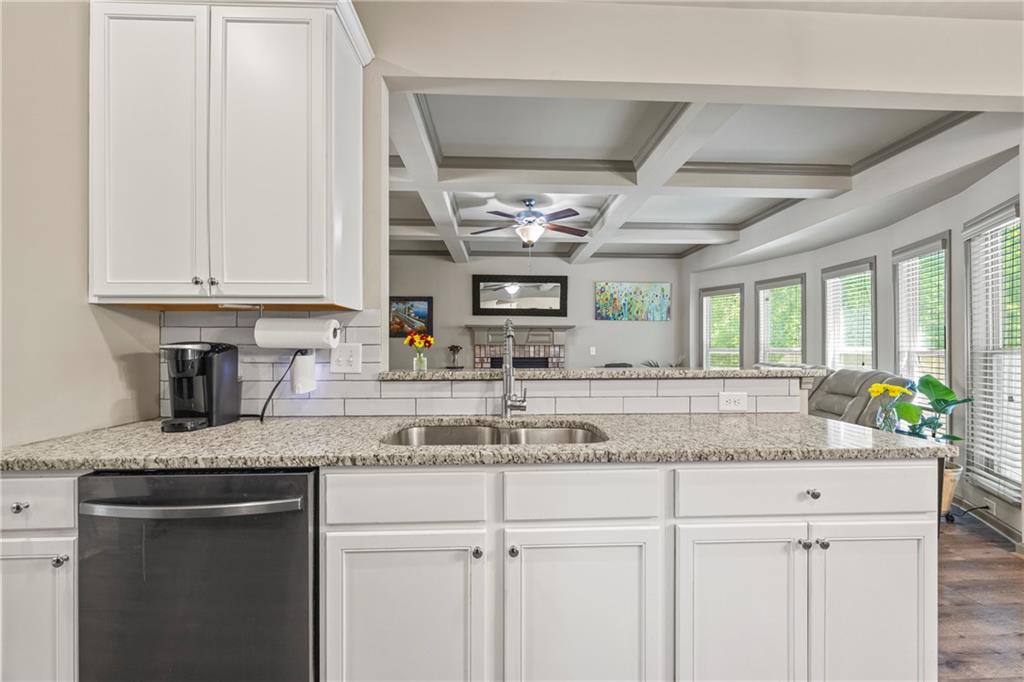816 Mimosa Way Jefferson, GA 30549 - Photo 25 of 83 a kitchen with granite countertop a sink stainless steel appliances white cabinets and a window