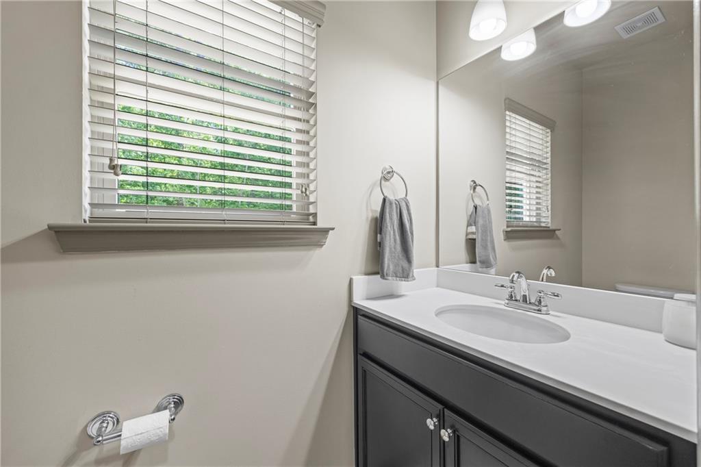 816 Mimosa Way Jefferson, GA 30549 - Photo 33 of 83 a bathroom with a sink and a mirror