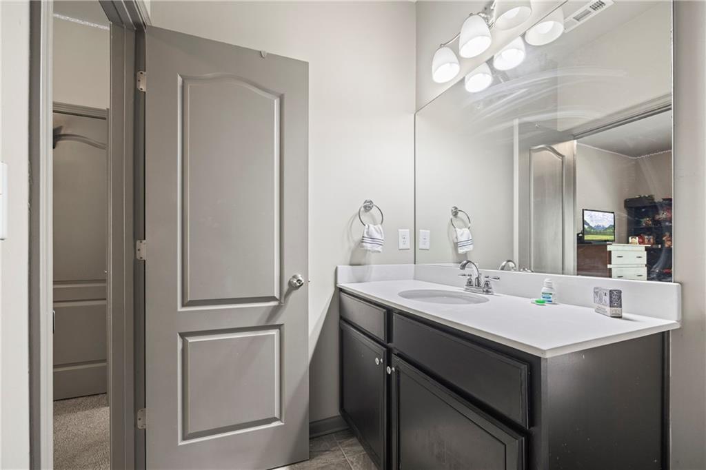 816 Mimosa Way Jefferson, GA 30549 - Photo 43 of 83 a bathroom with a sink vanity and a mirror