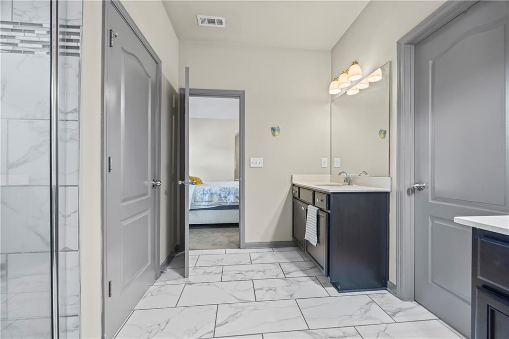 816 Mimosa Way Jefferson, GA 30549 - Photo 64 of 83 a bathroom with a sink a toilet and shower