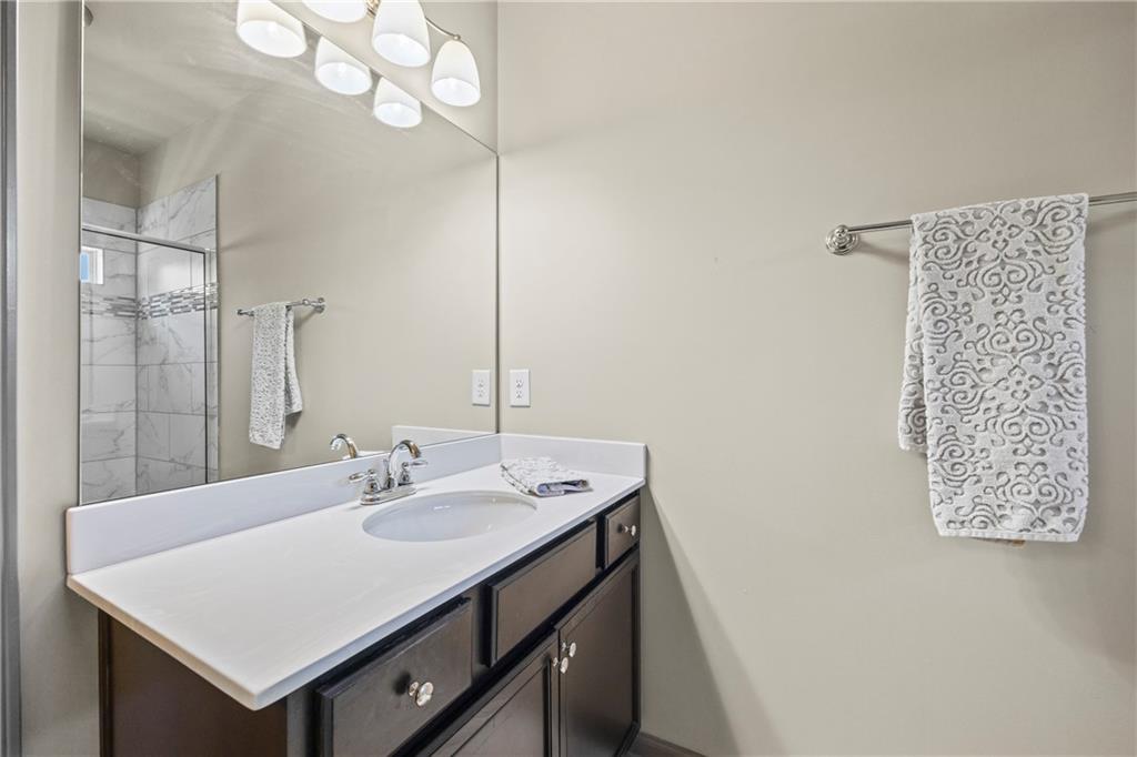 816 Mimosa Way Jefferson, GA 30549 - Photo 66 of 83 a bathroom with a sink vanity and a mirror