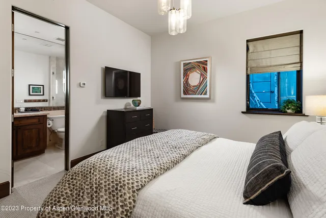 a bedroom with a bed and a television