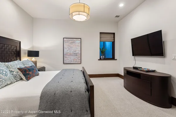 a bedroom with a bed and a flat screen television