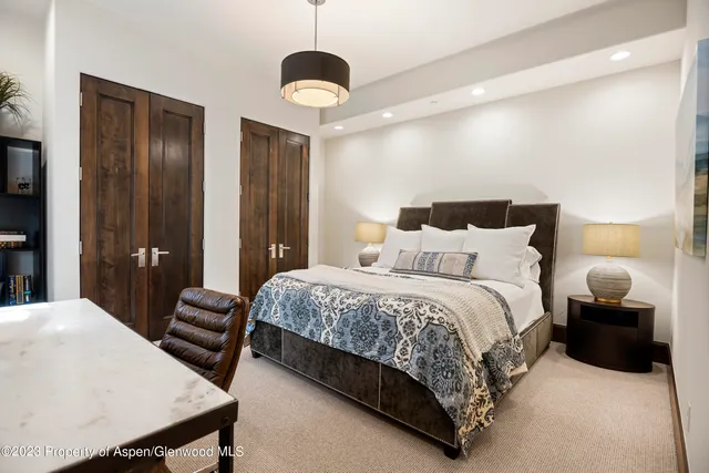 a bedroom with a bed and a chandelier