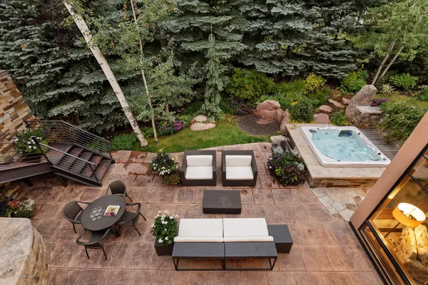 a view of a patio with couches table and chairs with potted plants