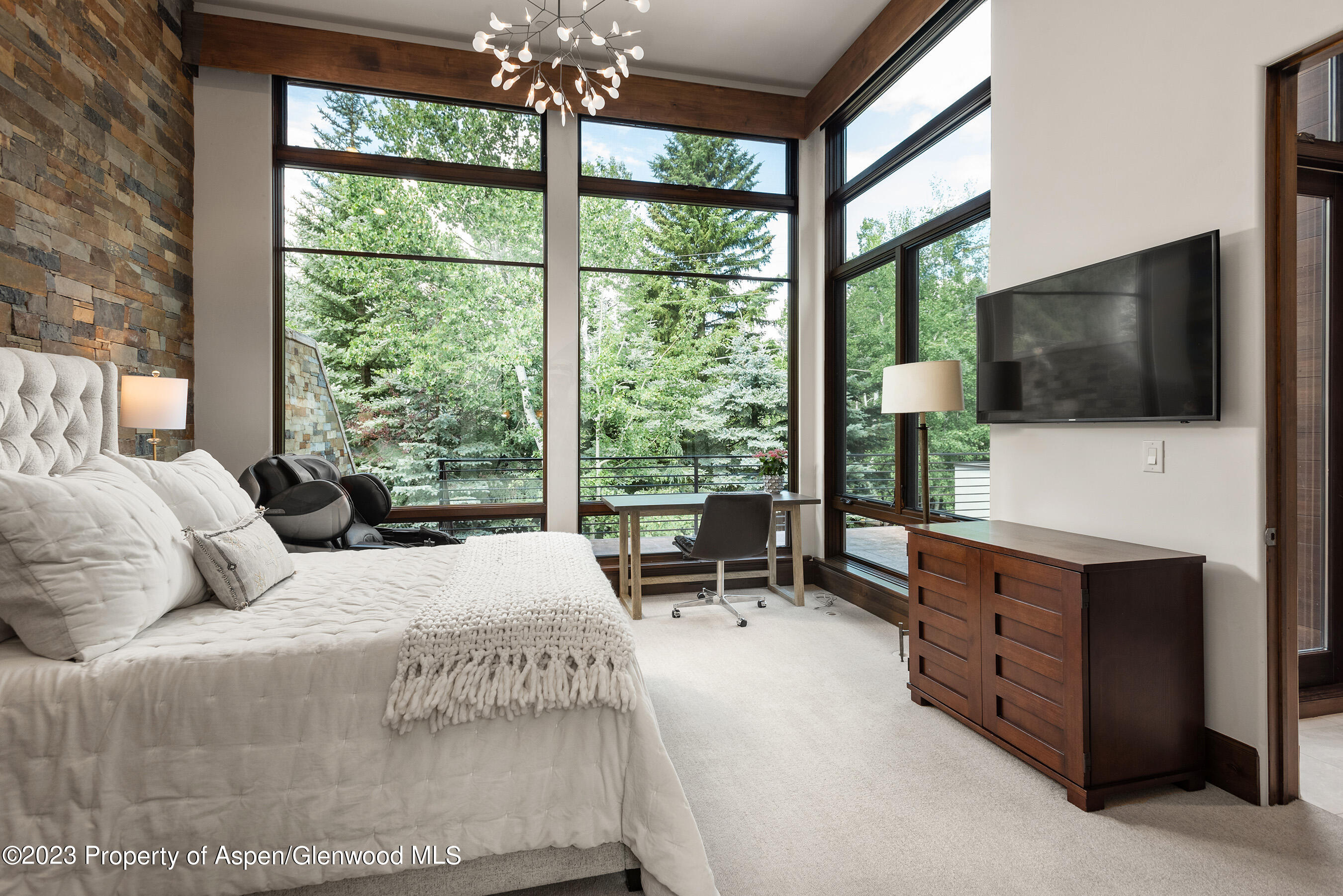 138 West Lupine Drive Aspen, CO 81611 - Photo 10 of 24 a bedroom with a large bed and a flat tv screen on dresser