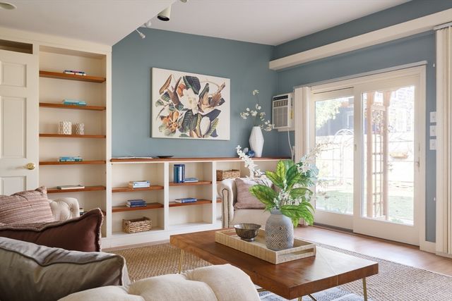 a living room with furniture lamp and large window