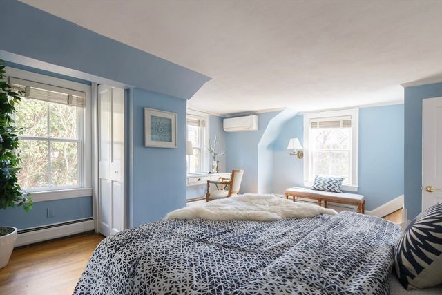 a bedroom with a large bed and a window