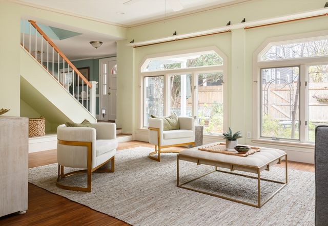 a living room with furniture a rug and a large window