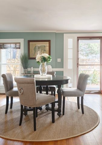 a dining room with furniture a rug and wooden floor