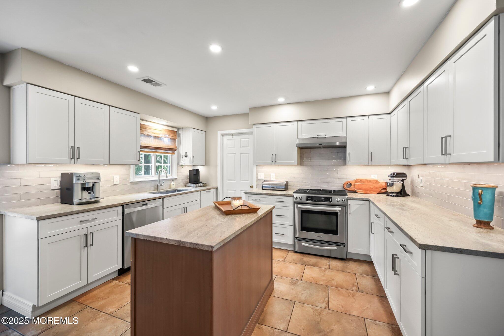 2 Independence Drive Aberdeen, NJ 07747 - Photo 14 of 43 a kitchen with a sink stove top oven and cabinets