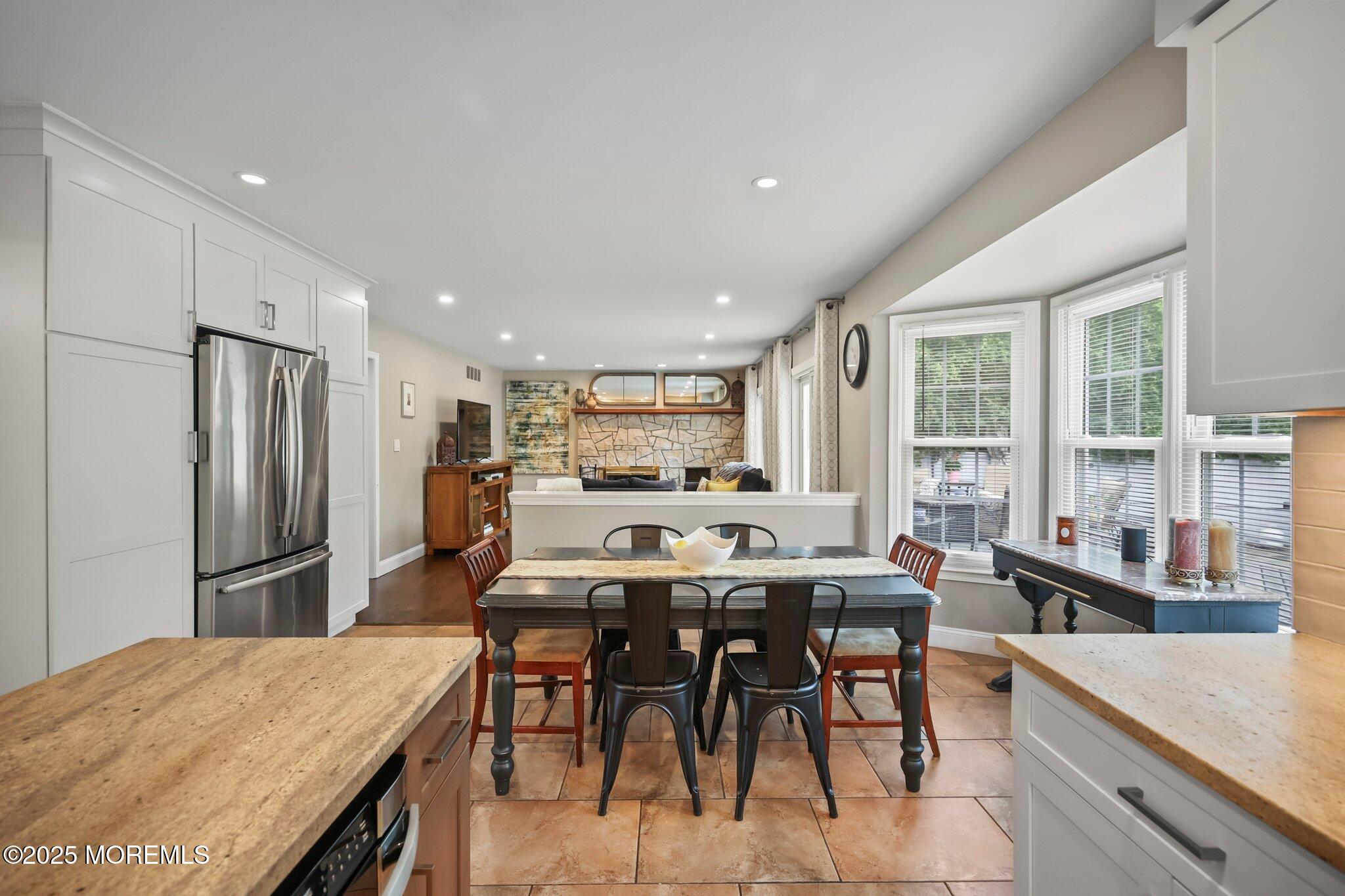 2 Independence Drive Aberdeen, NJ 07747 - Photo 16 of 43 a kitchen with stainless steel appliances kitchen island granite countertop a dining table chairs and refrigerator