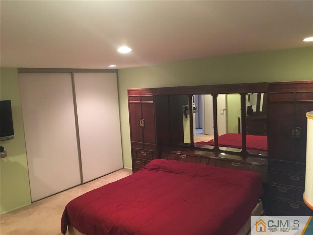 6804 Hana Road Edison, NJ 08817 - Photo 14 of 25 a bedroom with a bed and a large window