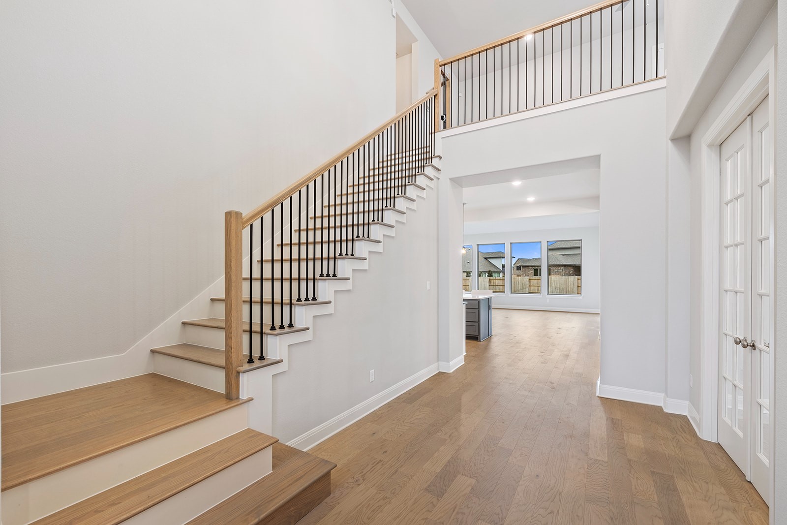 105 Bull Rdg Trail Georgetown, TX 78628 - Photo 15 of 36 a view of a hallway with wooden floor and staircase