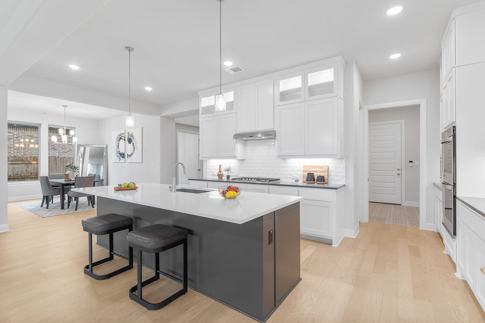 105 Bull Rdg Trail Georgetown, TX 78628 - Photo 8 of 36 a kitchen with a sink a counter top appliances and a center island
