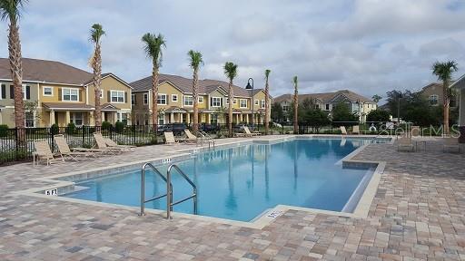 7652 Ripplepointe Way Windermere, FL 34786 - Photo 19 of 21 a view of swimming pool with outdoor seating and trees in the background