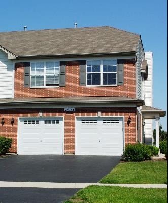 24136 Walnut Circle Plainfield, IL 60585 - Photo 1 of 17 a front view of a house with a yard and garage