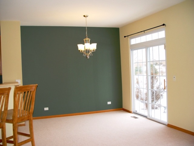 24136 Walnut Circle Plainfield, IL 60585 - Photo 5 of 17 a view of an empty room with chandelier fan and a window