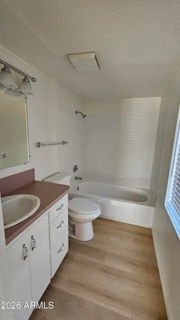 a bathroom with a granite countertop toilet a sink and bathtub