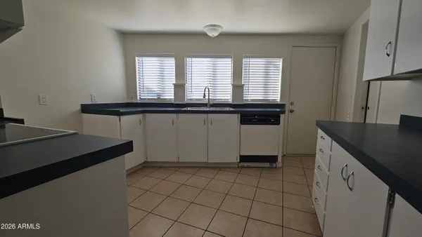 a kitchen with stainless steel appliances a sink and a refrigerator