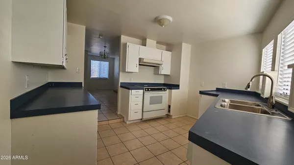 a kitchen with a sink and a stove top oven