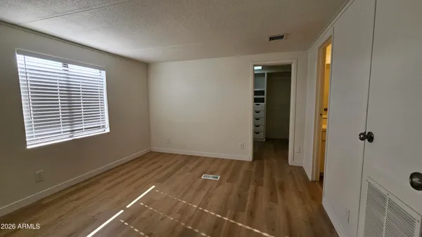 a view of a room with wooden floor and windows