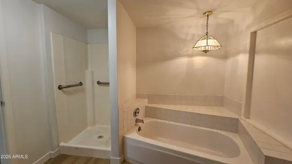 a bath tub sitting next to a shower