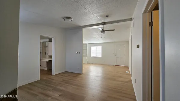 a view of empty room with wooden floor