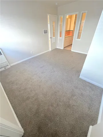 a view of an empty room and a window