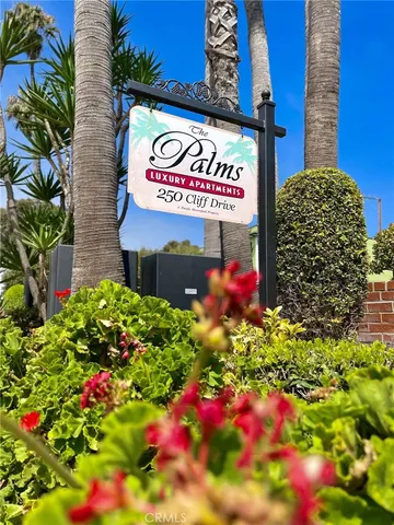 a sign that is in front of flowers