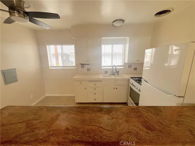 a view of a kitchen with a sink cabinets and a window