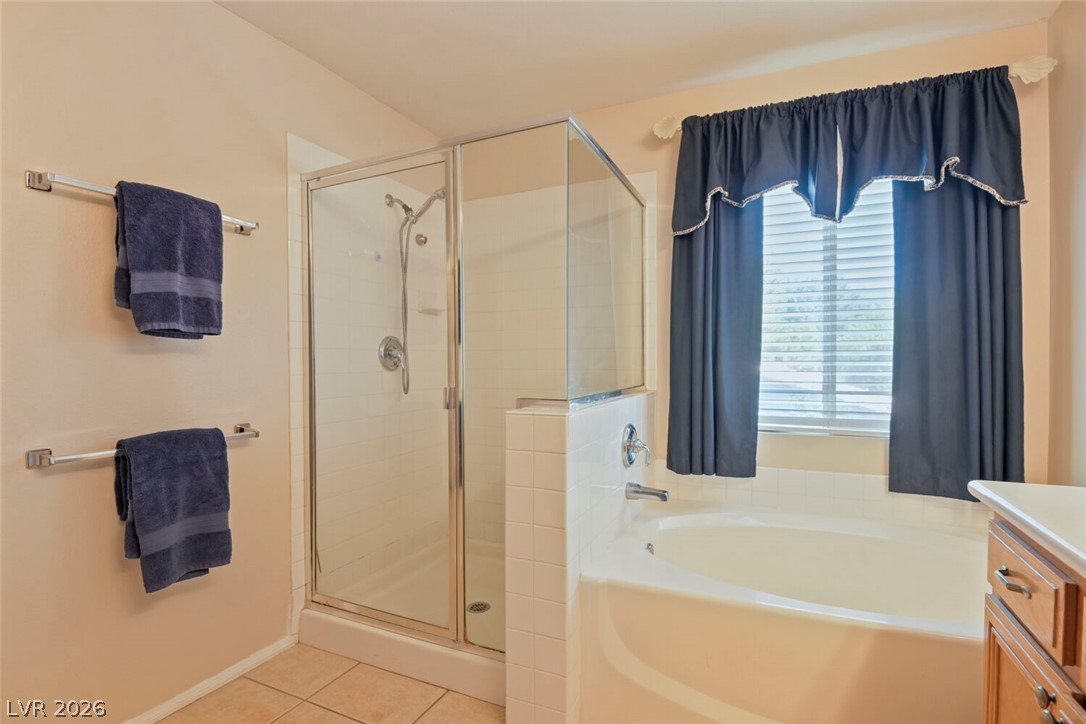 2356 Tilden Way Henderson, NV 89074 - Photo 19 of 30 Relax in the deep soaking tub or refresh in the sleek glass-enclosed shower of this well-appointed bathroom.