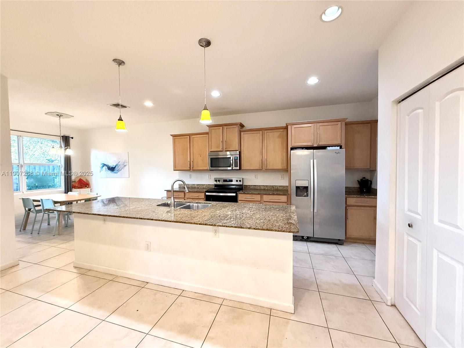 1740 Northwest 21st Street Homestead, FL 33030 - Photo 11 of 23 a large kitchen with granite countertop a large counter top stainless steel appliances and cabinets