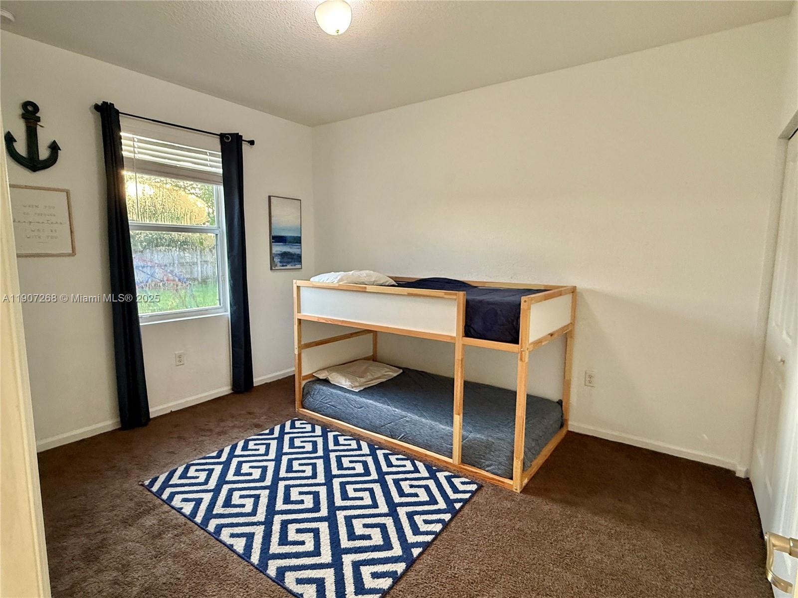 1740 Northwest 21st Street Homestead, FL 33030 - Photo 18 of 23 a bedroom with a bed and a window