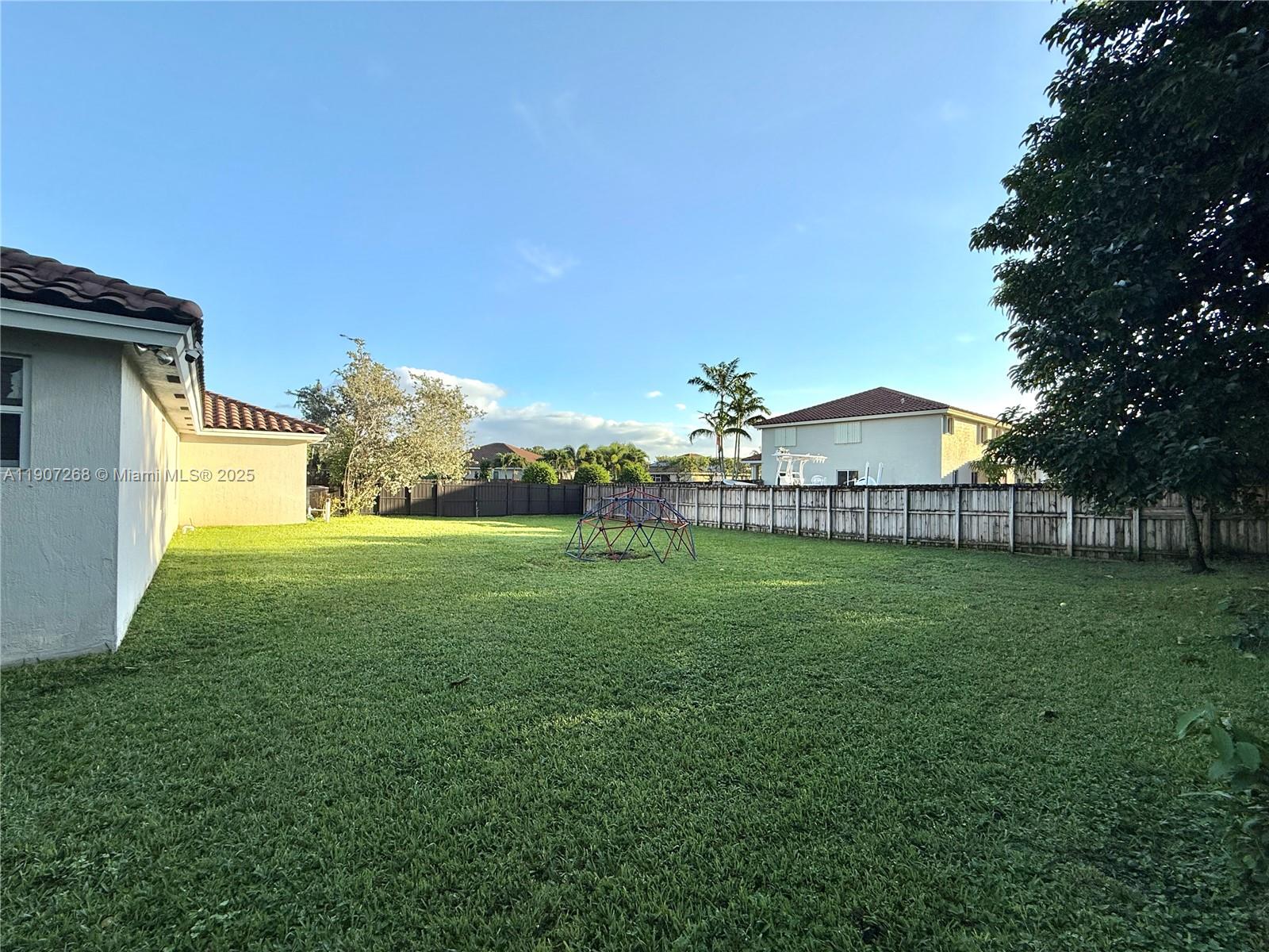 1740 Northwest 21st Street Homestead, FL 33030 - Photo 3 of 23 a view of a house with garden and a trees