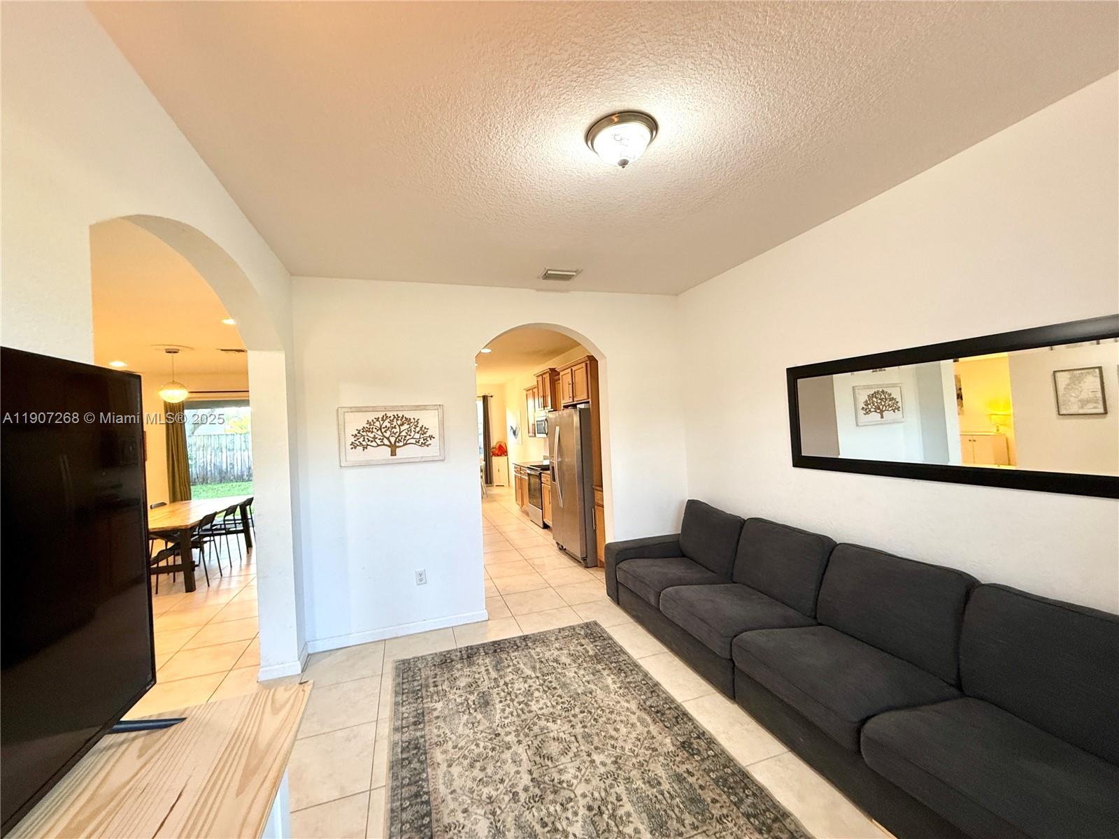 1740 Northwest 21st Street Homestead, FL 33030 - Photo 9 of 23 a living room with furniture and a flat screen tv