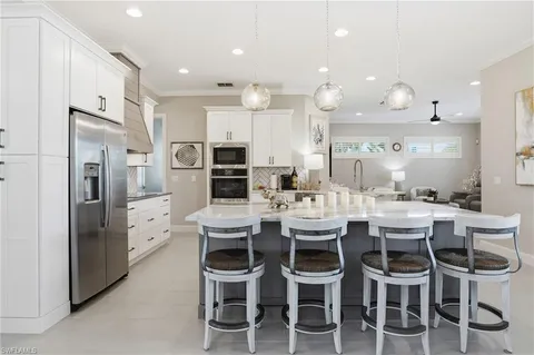 a large kitchen with a table and chairs