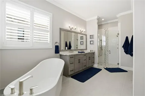 a bathroom with a double vanity sink a mirror a window and a shower