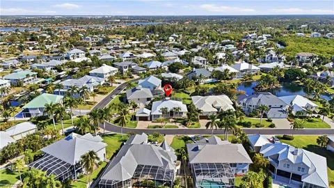 an aerial view of a houses with a swimming pool