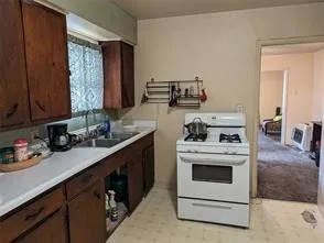 a kitchen with a stove top oven sink and cabinets