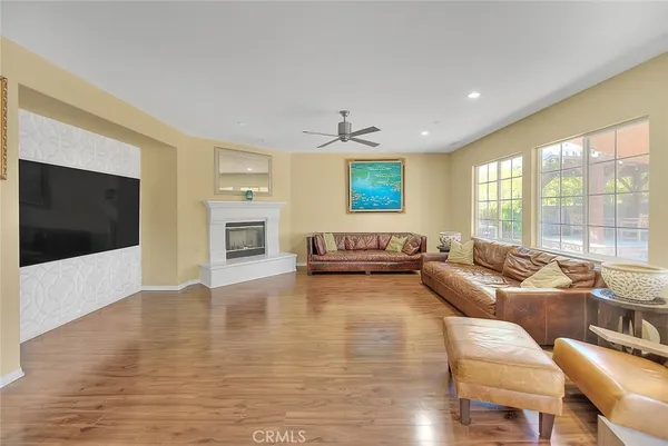 a living room with furniture a flat screen tv and a window