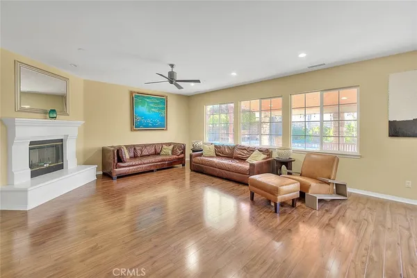 a bedroom with a bed lamp and a larger window