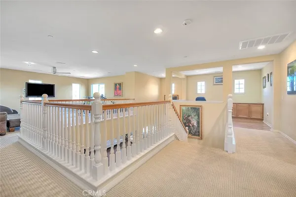a kitchen with white cabinets and sink